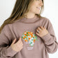 Custom embroidered wedding bouquet on clay crewneck sweatshirt with name and date