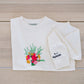 Custom embroidered bouquet crewneck in ivory color laid flat with name and date on sleeve