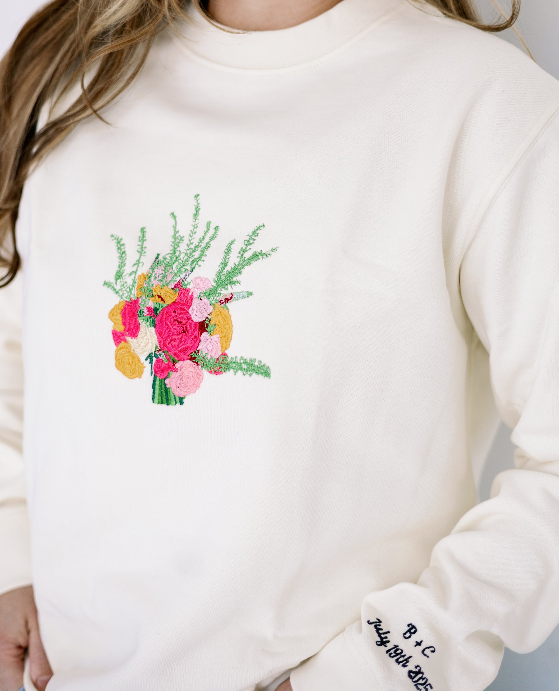 Custom embroidered wedding bouquet on ivory crewneck sweatshirt with name and date